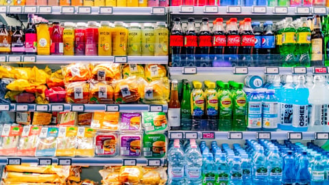 refrigerated shelves with snacks, prepared food and beverages