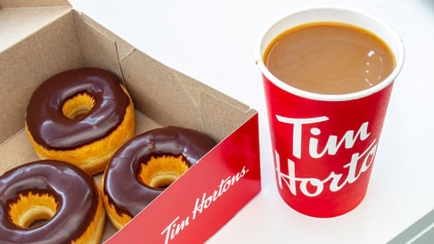 box of chocolate glazed Tim Hortons doughnuts with Tim Hortons coffee