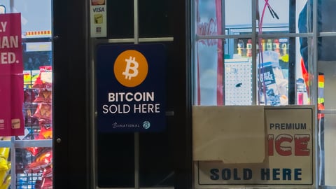Calgary, Alberta, Canada. Nov 27, 2025. Bitcoin Sold Here Sign Displayed on Convenience Store Window.
