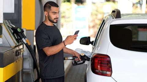Serious man at gas pump