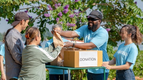 group of volunteers around a box marked "donations"