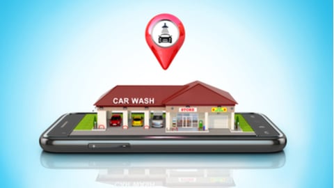 The building of the car wash and store is located on the smartphone. 3D illustration