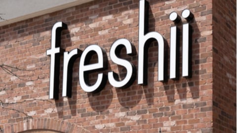 Close-up of Freshii restaurant sign on the building. Freshii is a Canadian fast casual restaurant franchise that serves burritos, wraps, soups, salads, and frozen yogurt