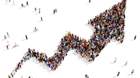 Large group of people gathered together in the shape of growing graph arrow