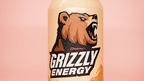 Grizzly Energy Sour Gummy can on pink background