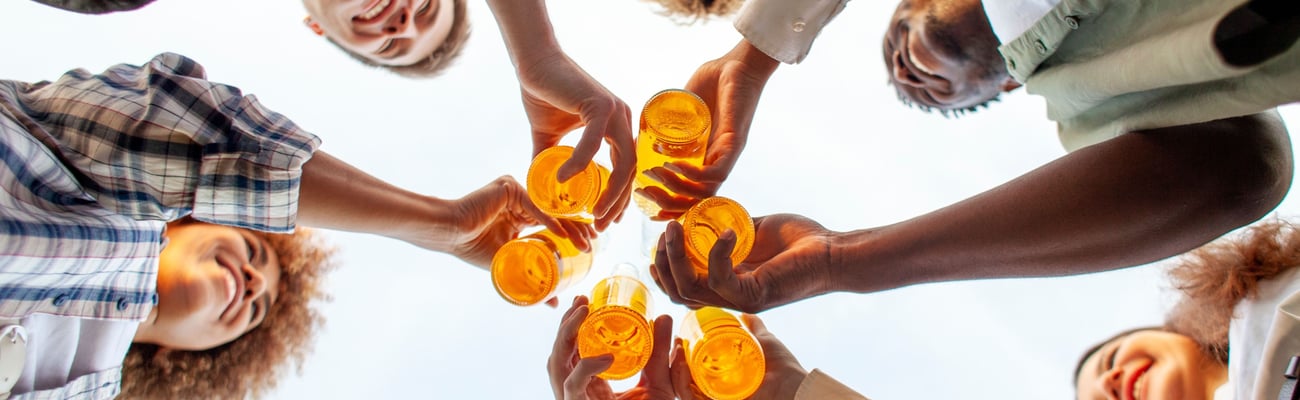 Group of people toasting from below