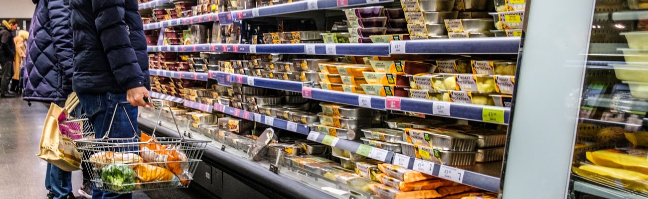 white male looking at food shelves in store