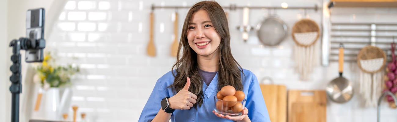 food influencer in front of camera holding eggs