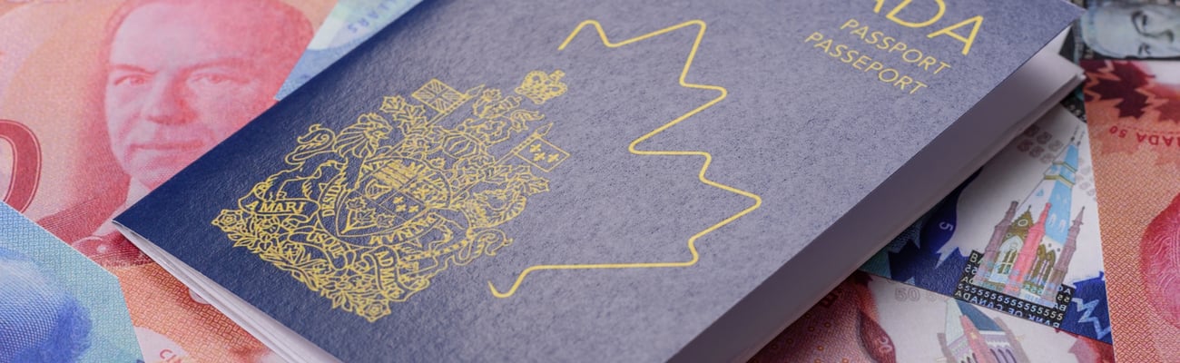 passport on top of Canadian currency