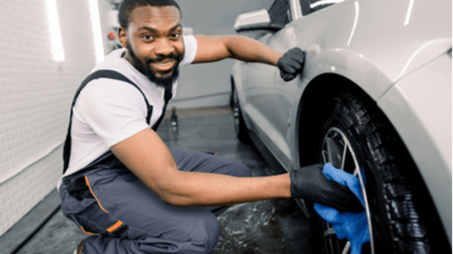 man washing car wheel