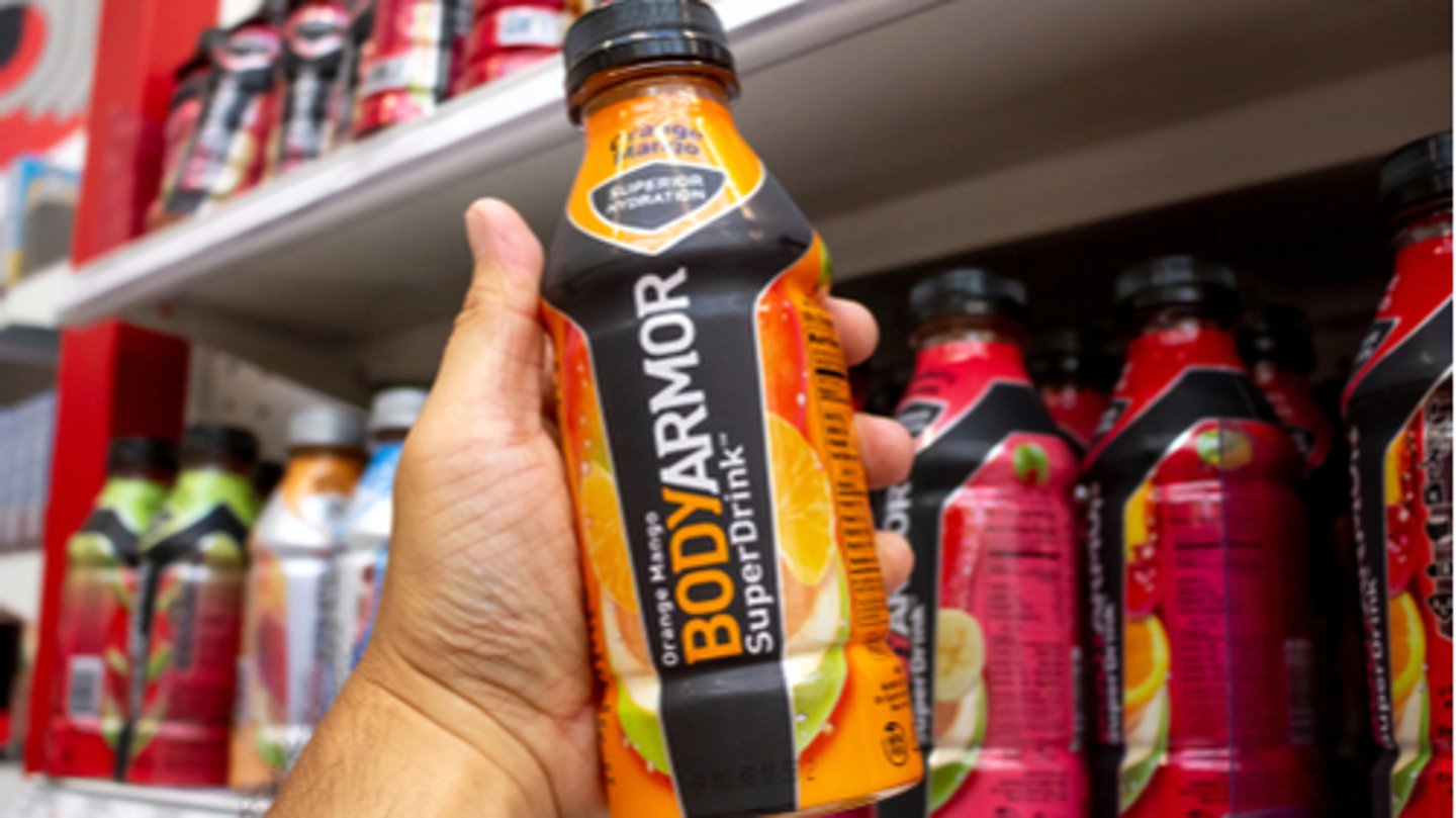 A hand hold a bottle of Body Armor, or BodyArmor at a grocery store  T