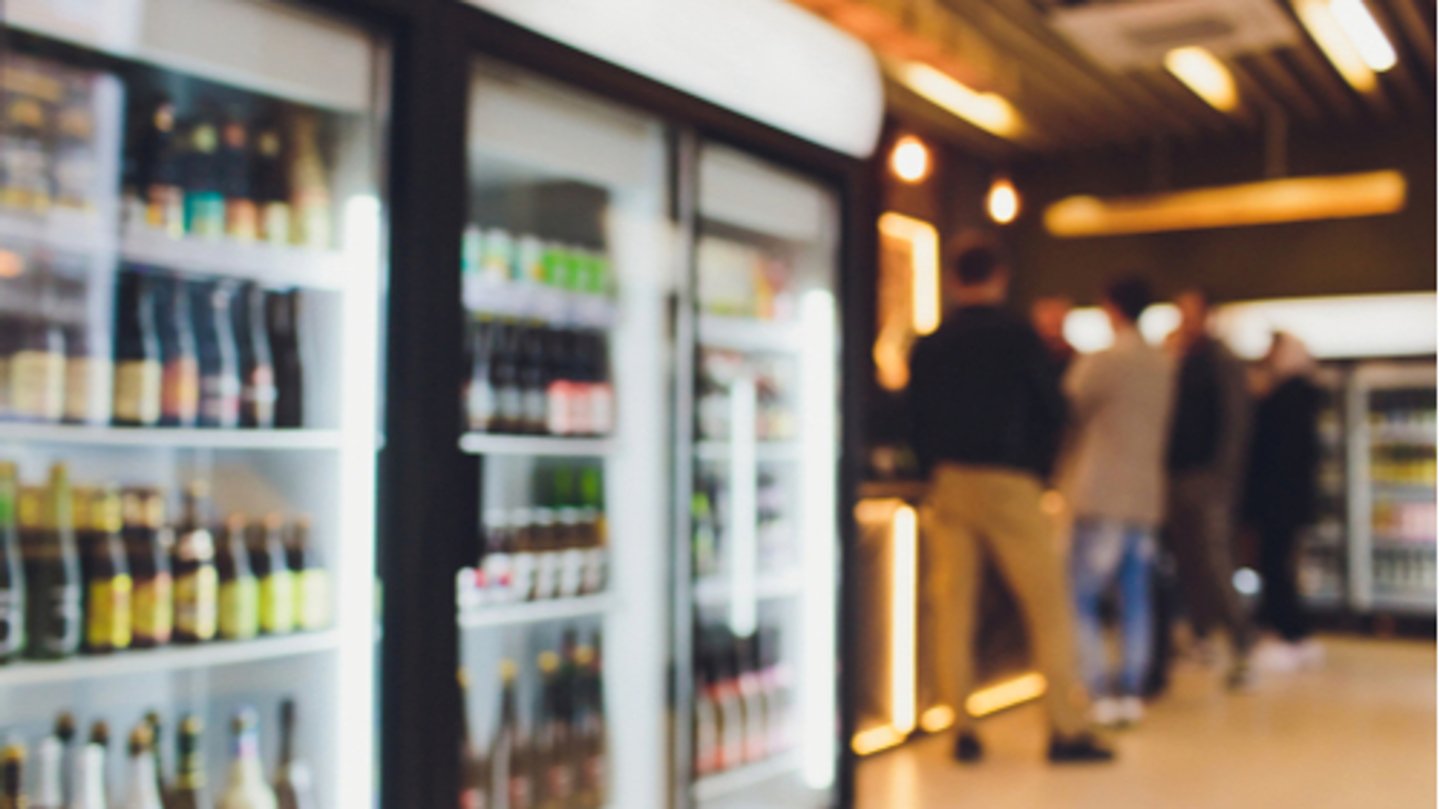 Background Blurred Defocused Beers are cooling in fridge, freezer or refrigerator shelf. C-Store or Grocery Background concept image.