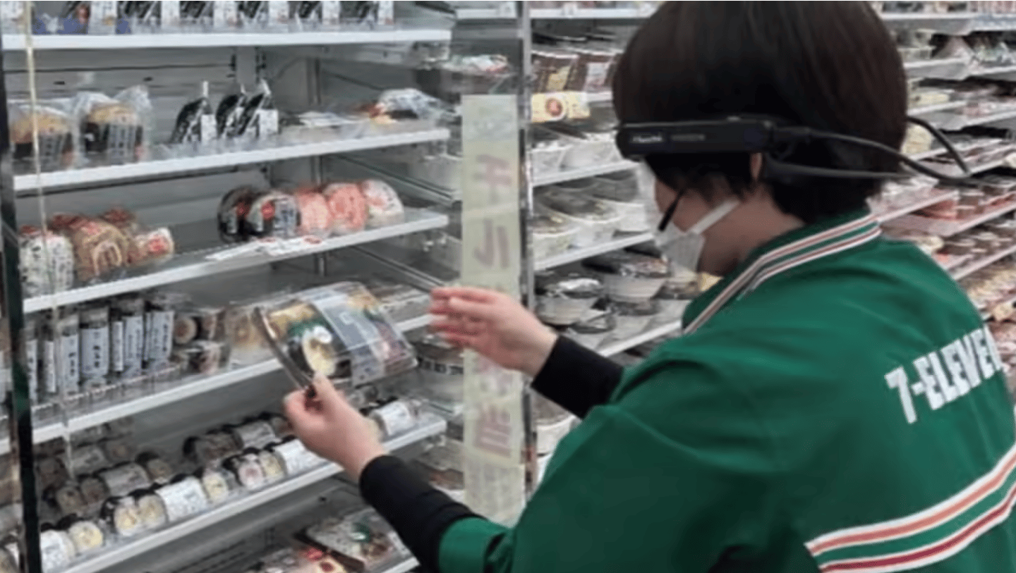 worker at 7-Eleven Japan helping a senior shop remotely