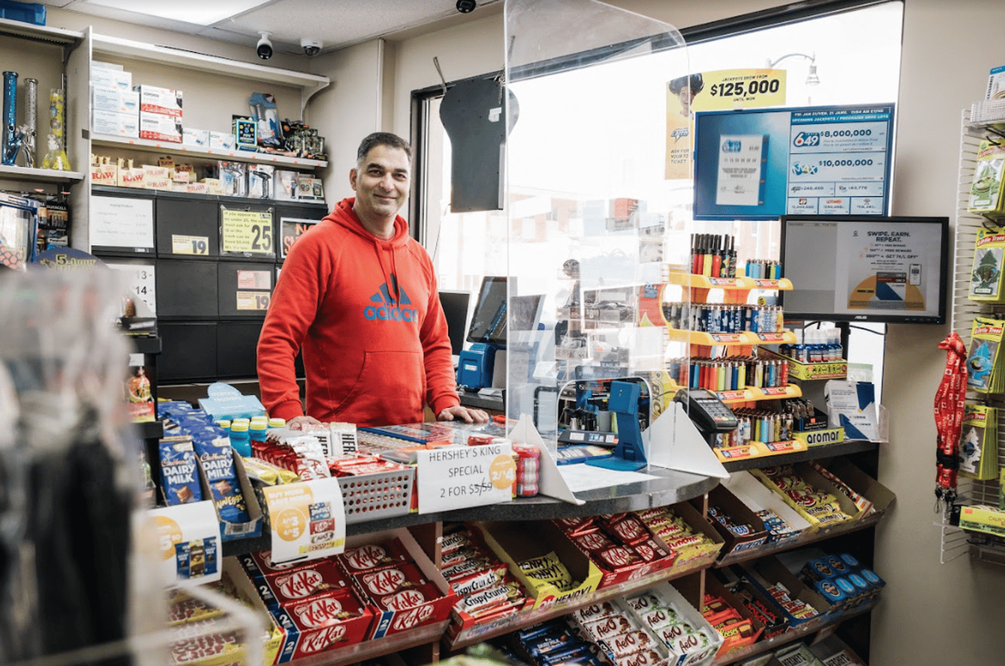 Kumar behind the counter at his convenience store