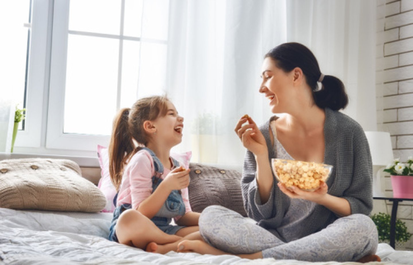 woman and child enjoying a bowl of popcorn