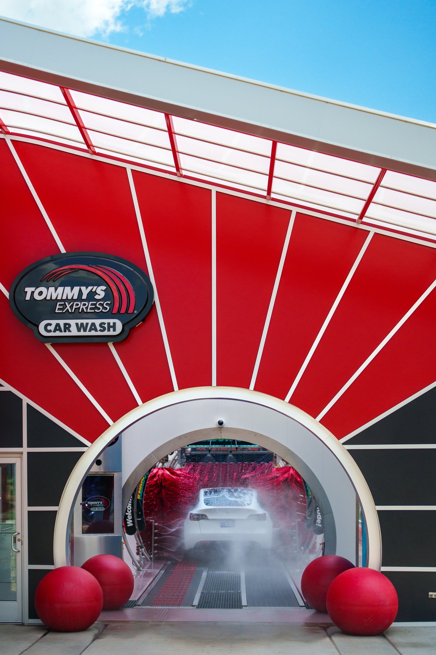 Tommy's Car Wash exterior shot with big red canopy and tunnel