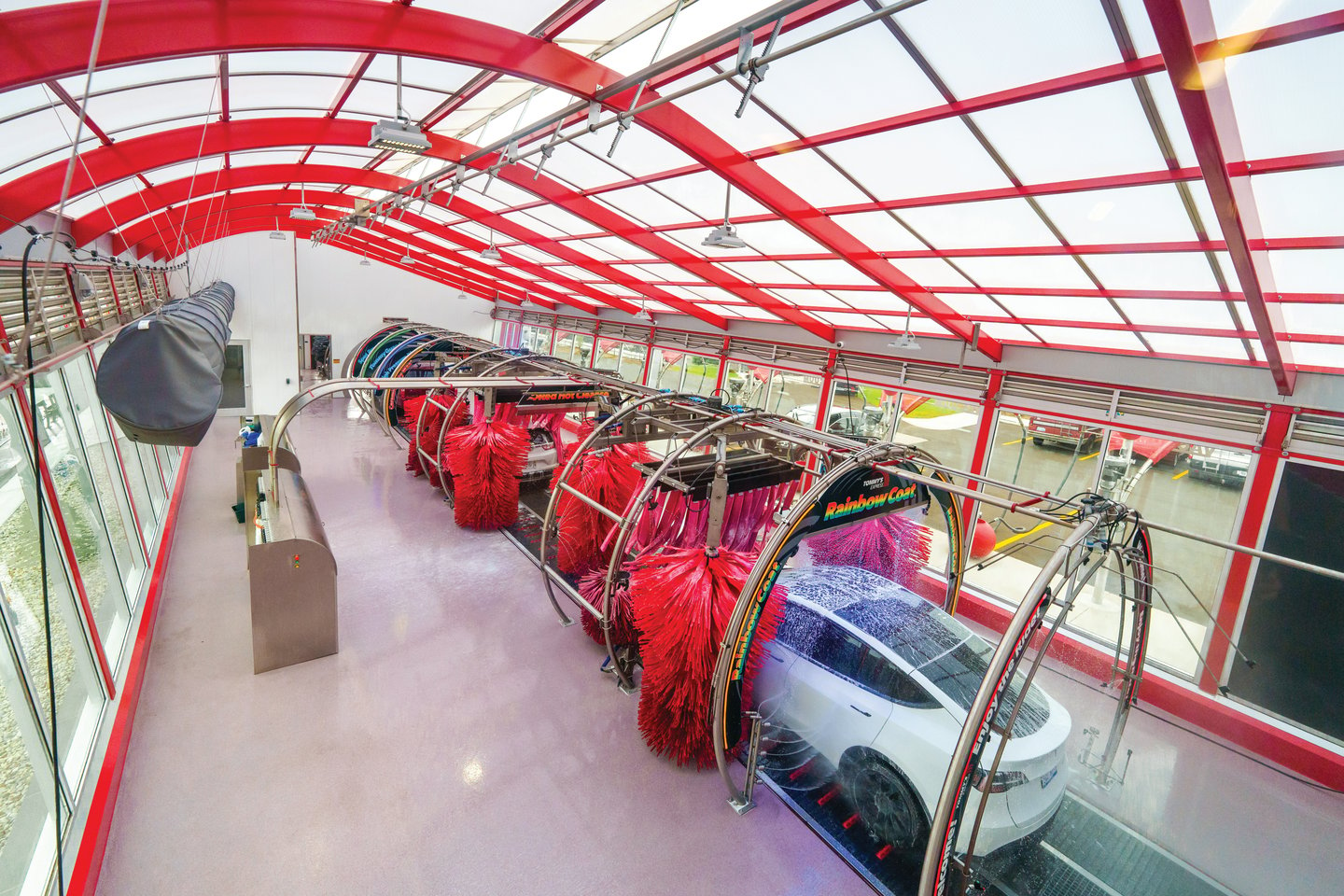 Interior shot from above of a car moving through the car wash tunnel