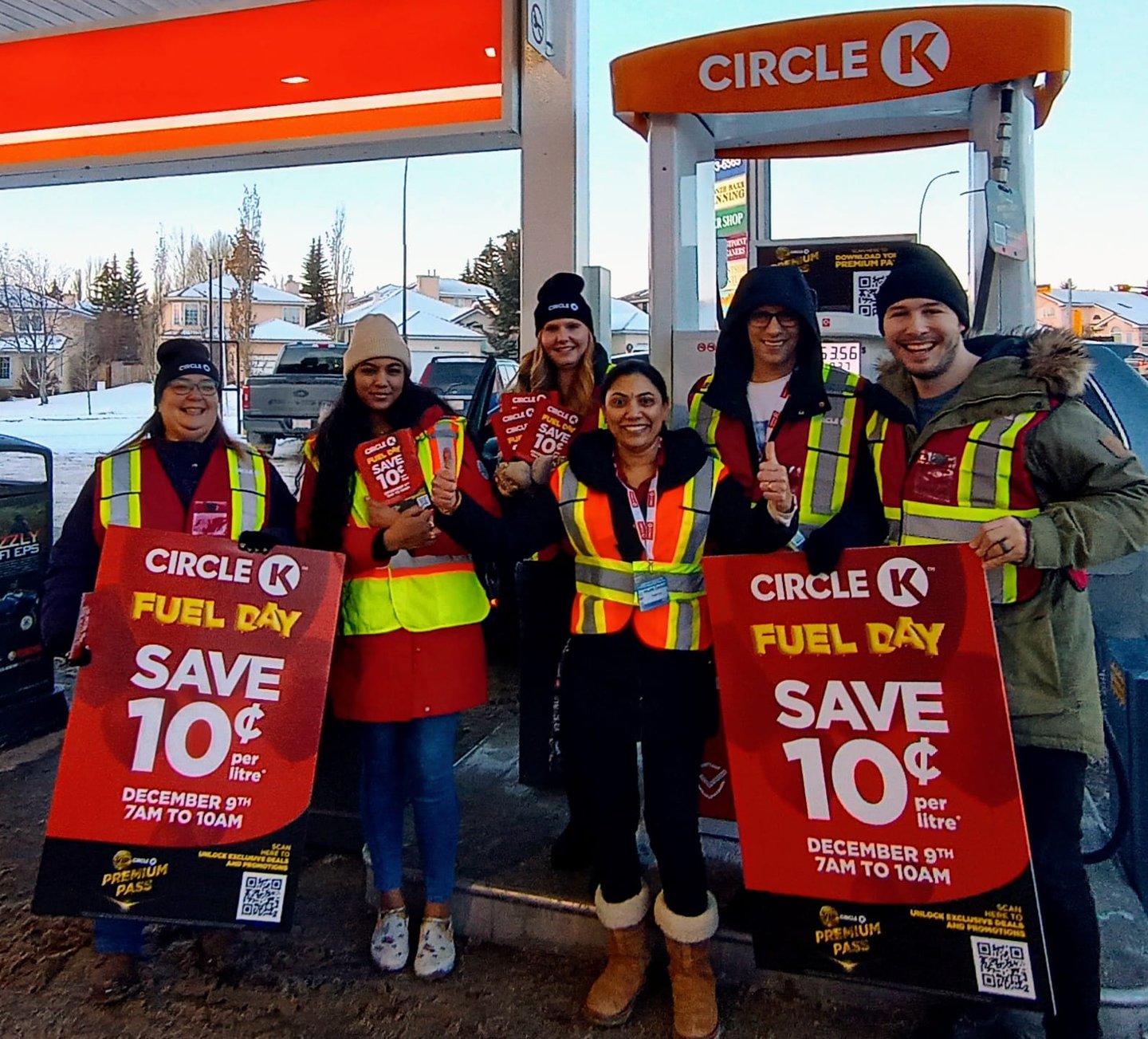 Team members hold up signage celebrating Circle K fuel day