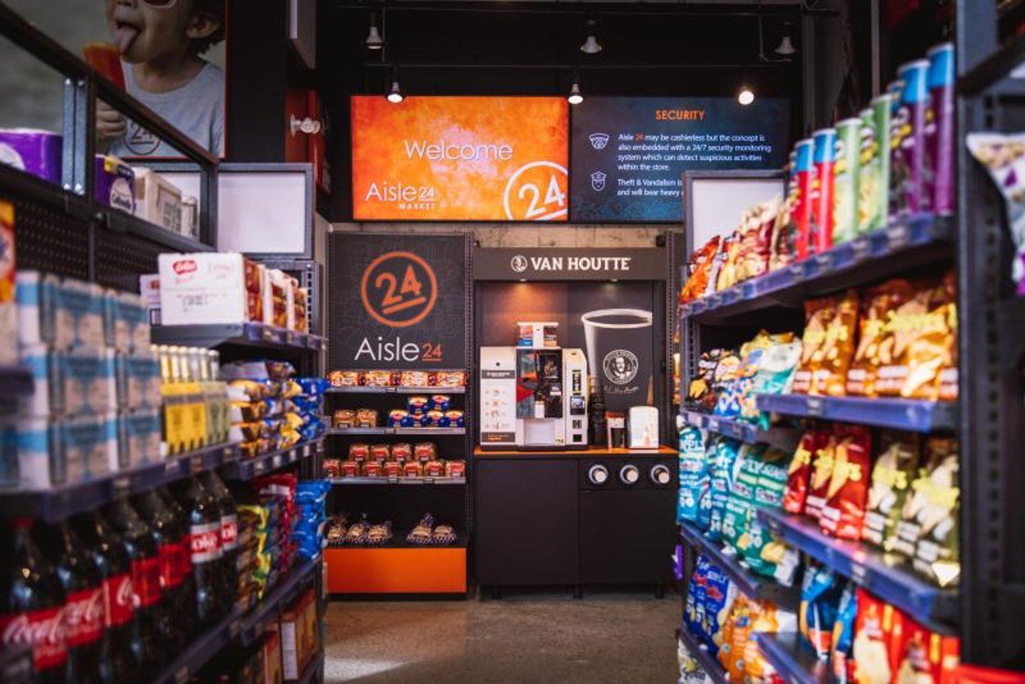 A retail food aisle with chips and soft drinks.