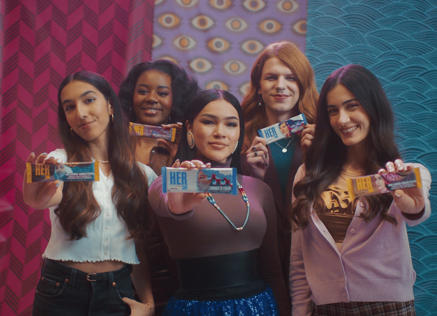 Five young women from Hershey Canada's HerShe campaign hold up chocolate bars.