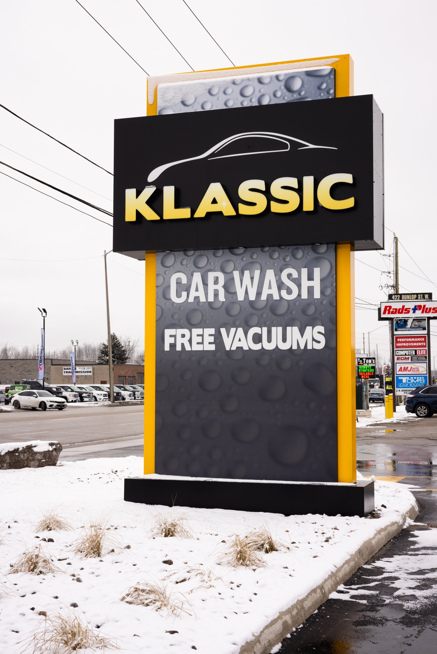 Klassic Car Wash sign on snowy street.