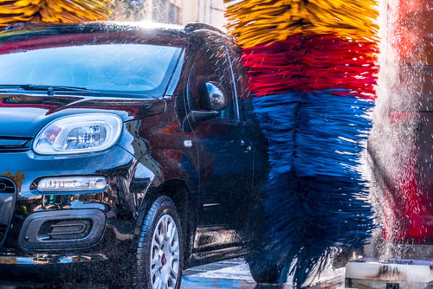 Car going through an automated car wash machine.