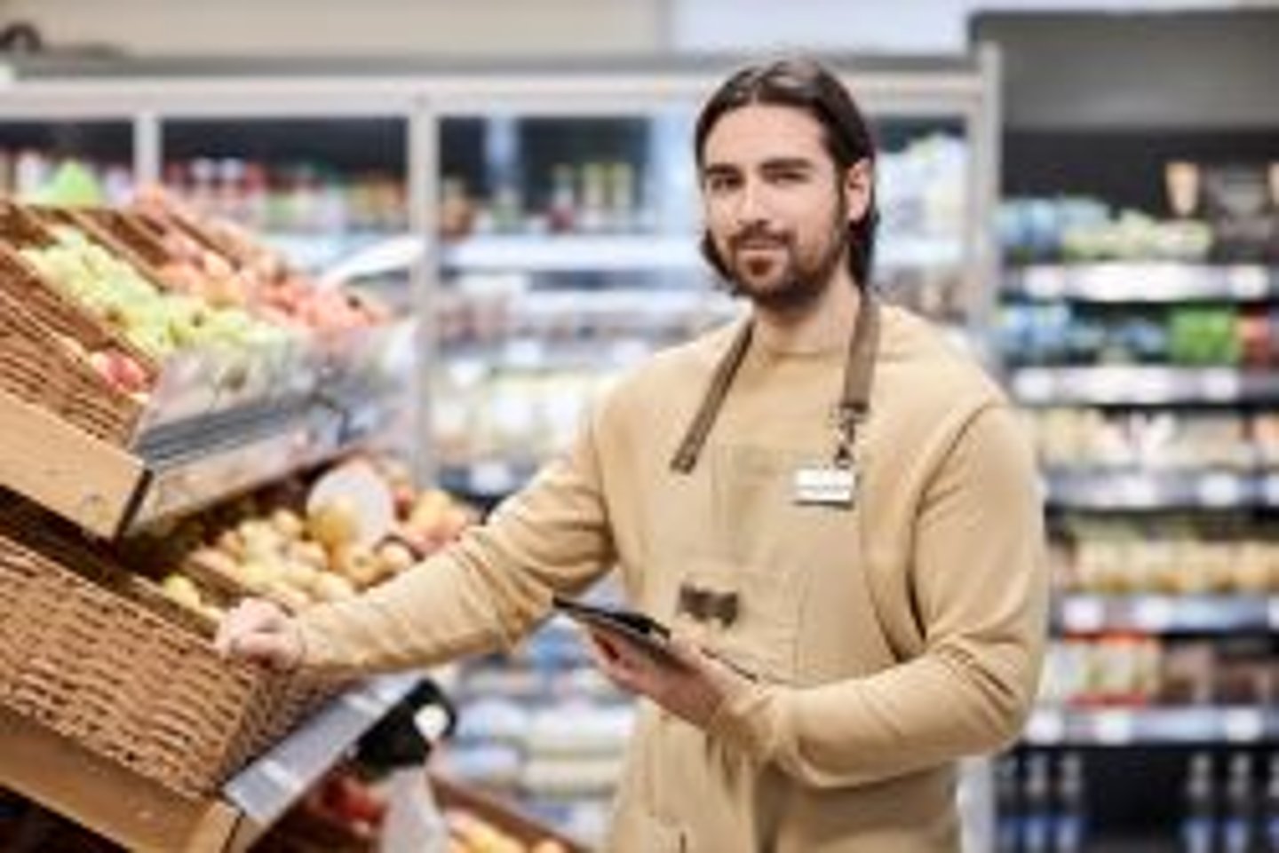 Convenience store employee putting out fresh food stock image