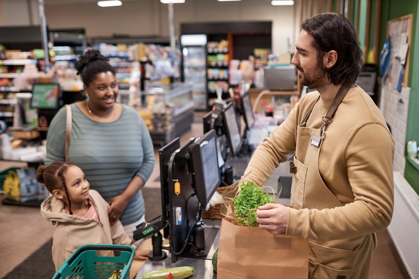 Woman and daughter checking out at a store