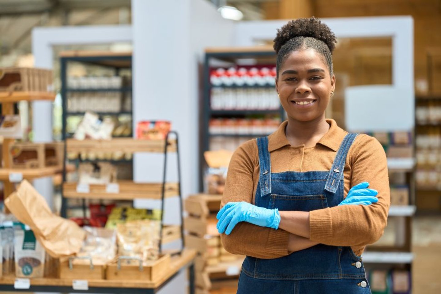 Female Store Worker Wearing Blue Safety Gloves stock image