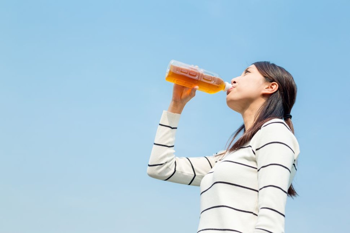 Woman drinking ice tea