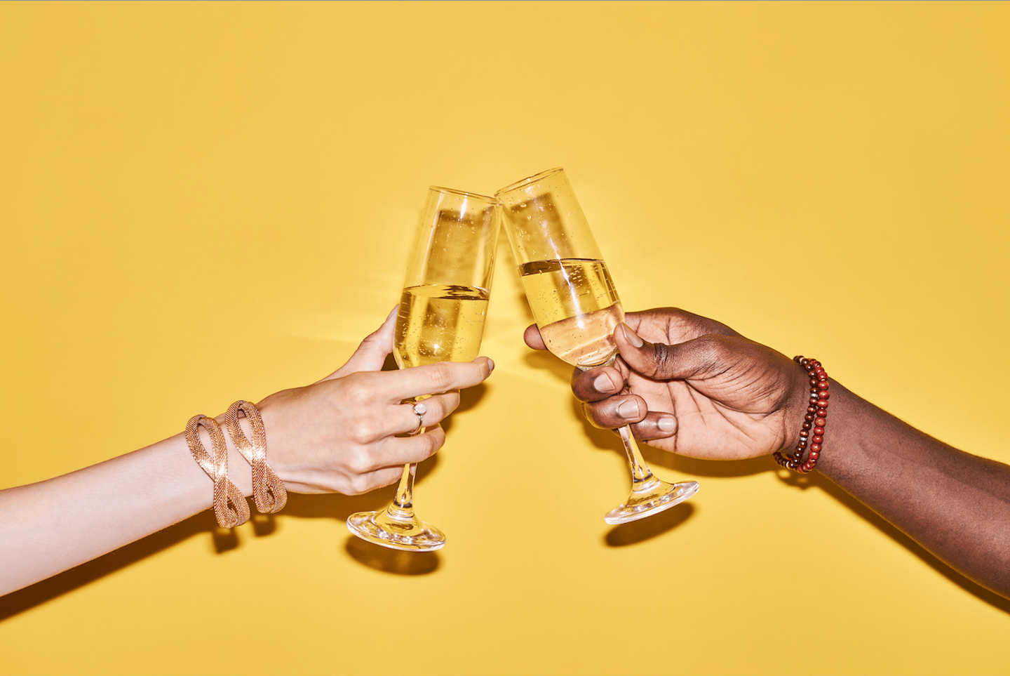 Cheers, sparkling wine, two hands in toast