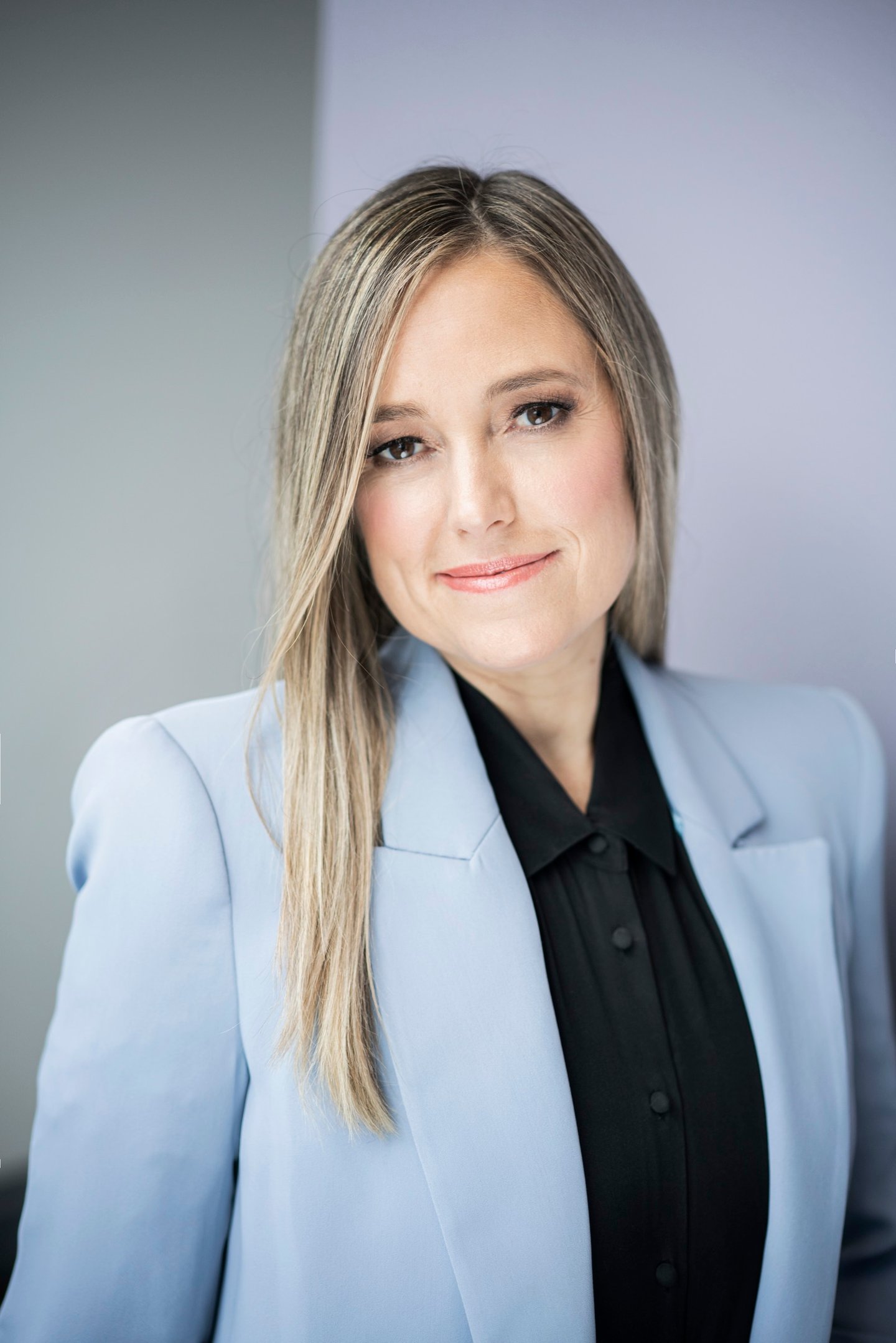 Amber Mac in a blue suit jacket