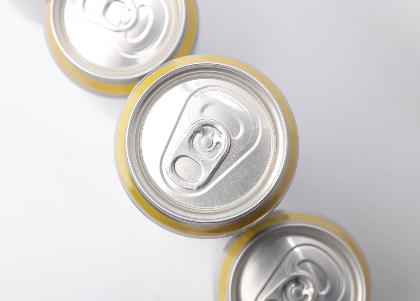 looking down at tops of beer cans with pull tab