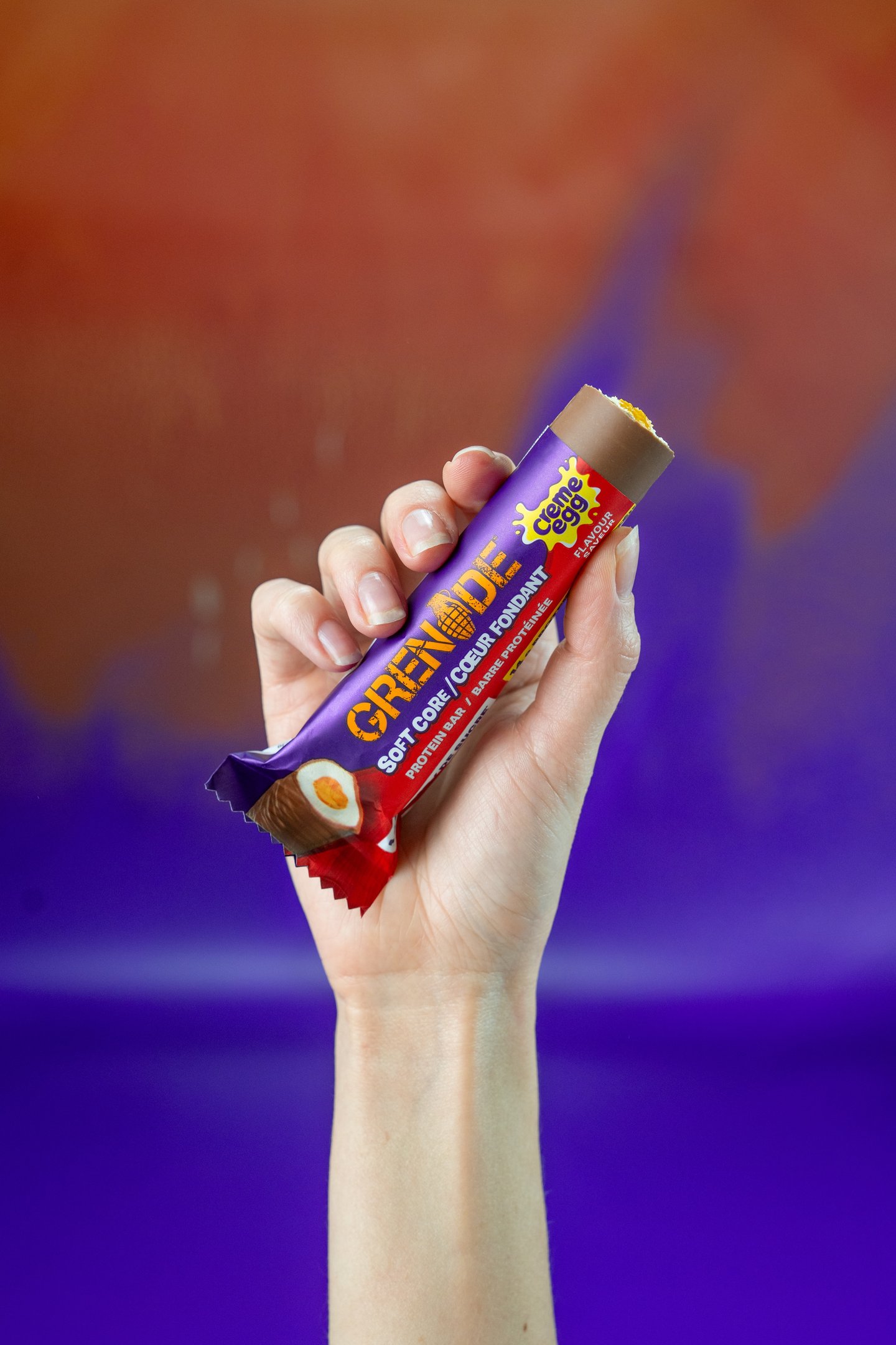 Grenade Cream-Egg inspired bar being held in the air