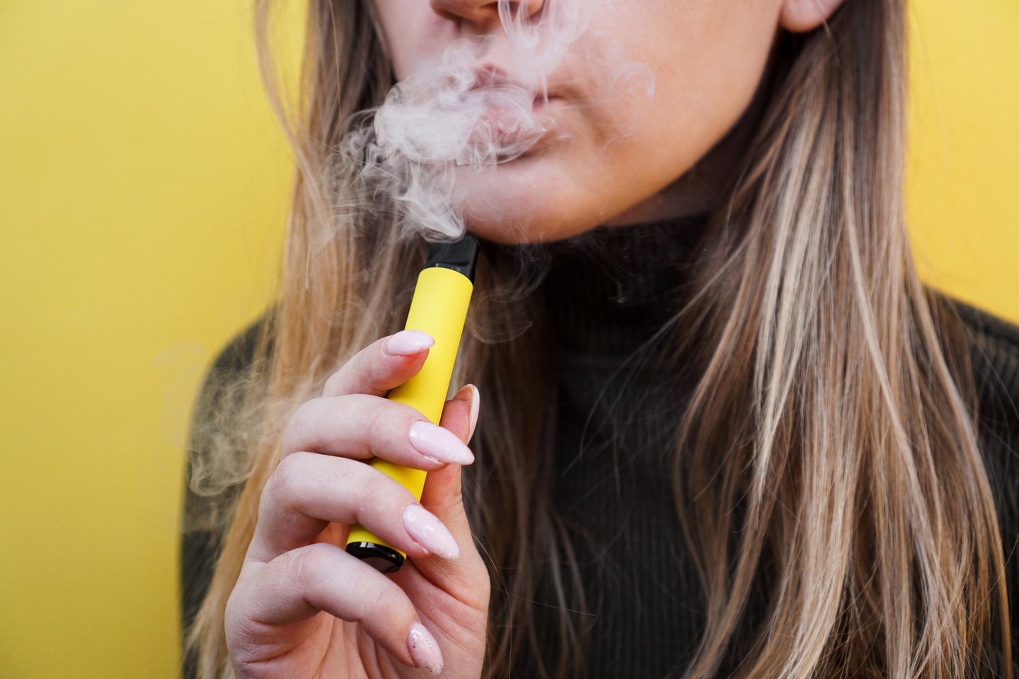 young white woman or girl with yellow vape, yellow background
