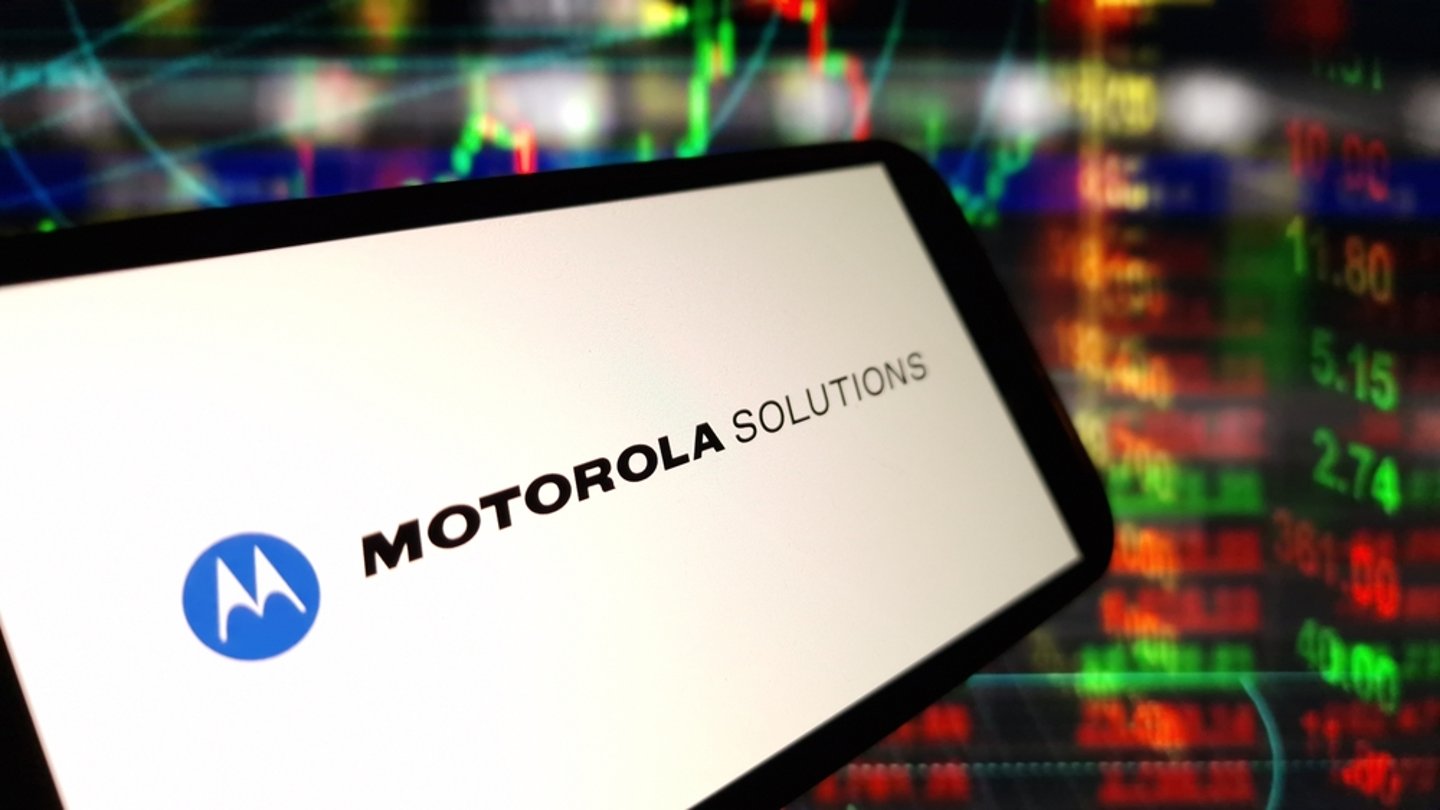 Motorola Solutions logo on a computer screen with digital readouts in the background.