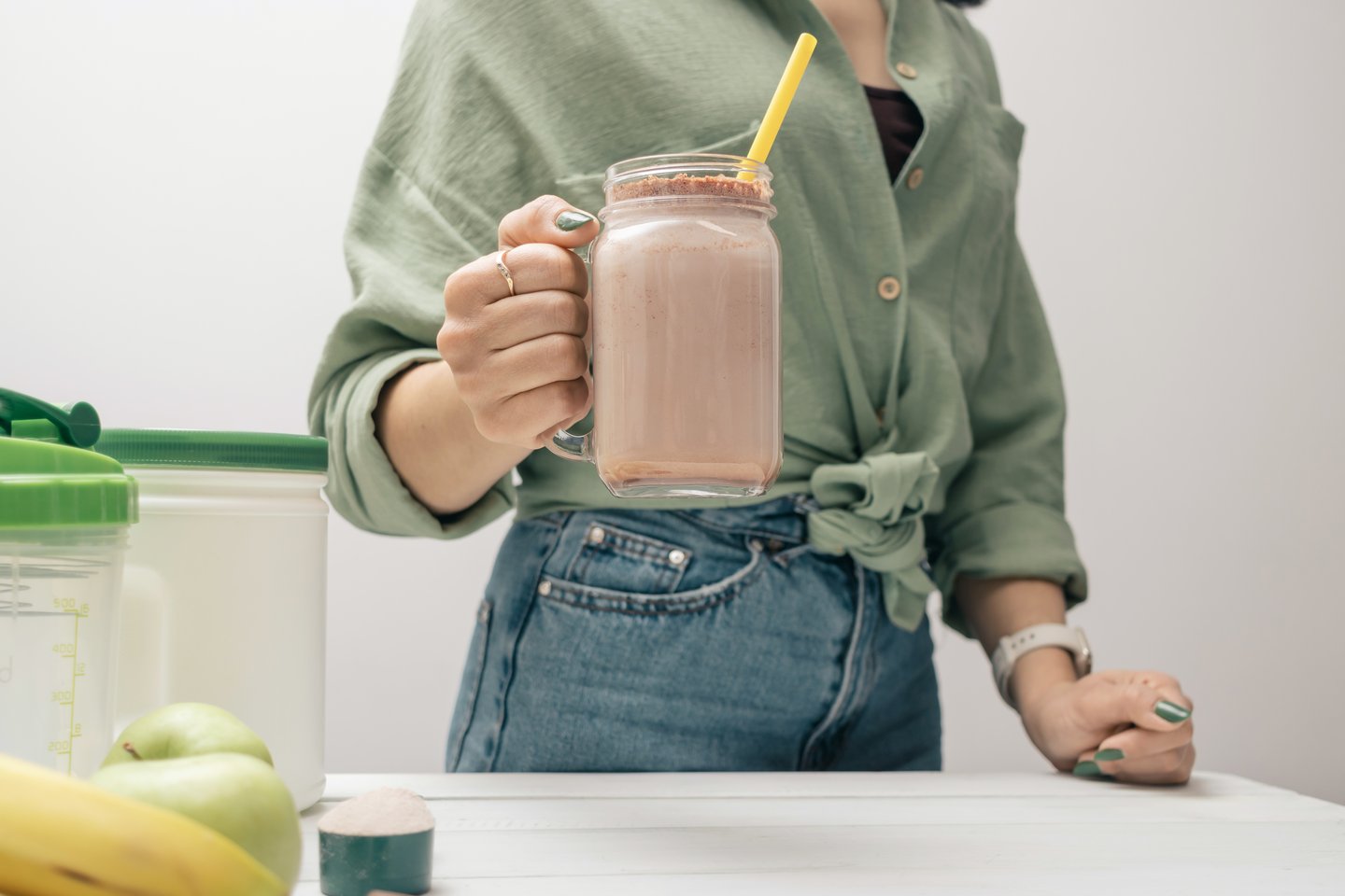 woman holding smoothie, banana yogurt peanut butter
