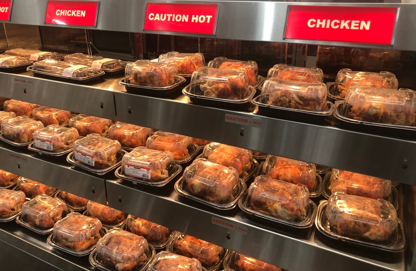 grocery case with rotisserie chickens