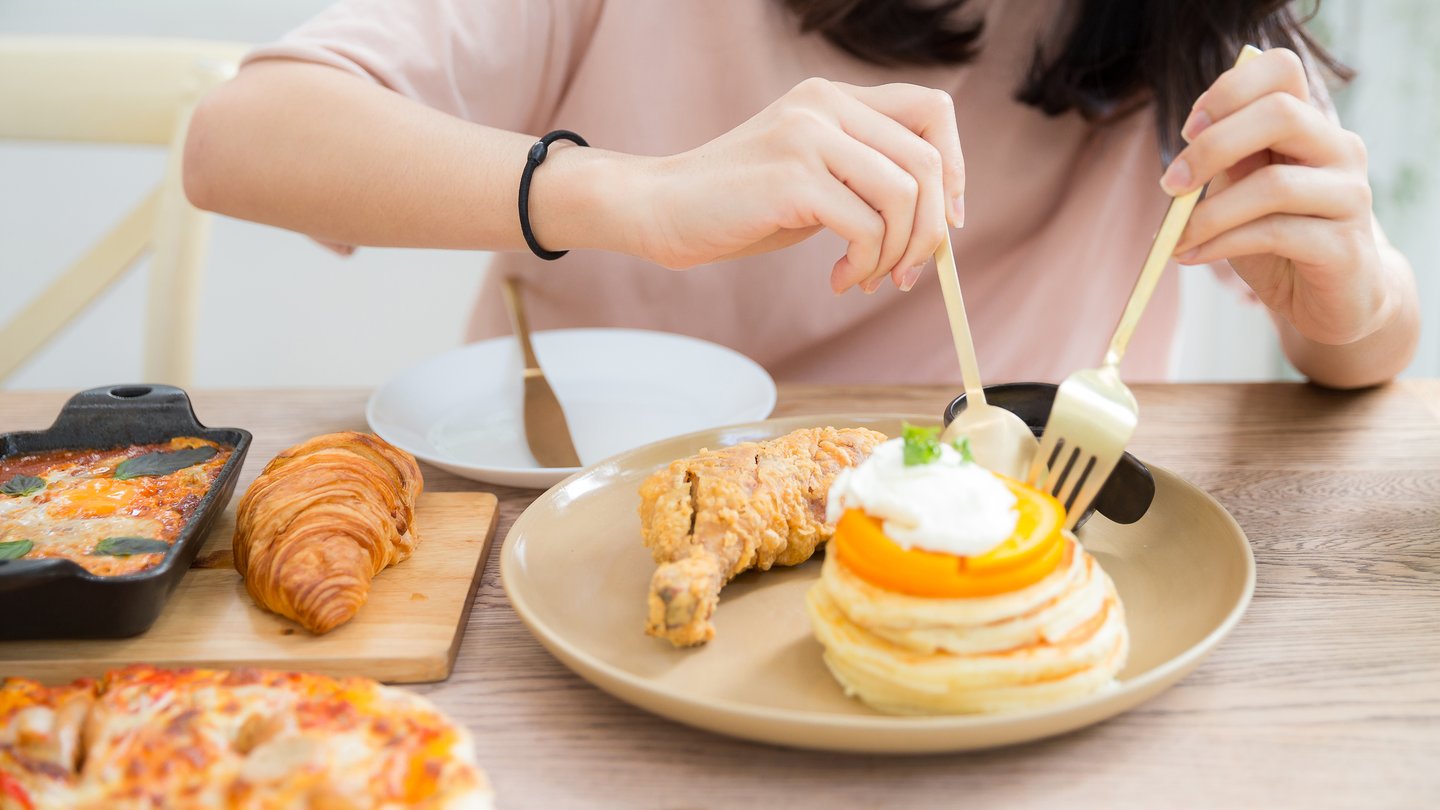 a woman eating a variety of foods.