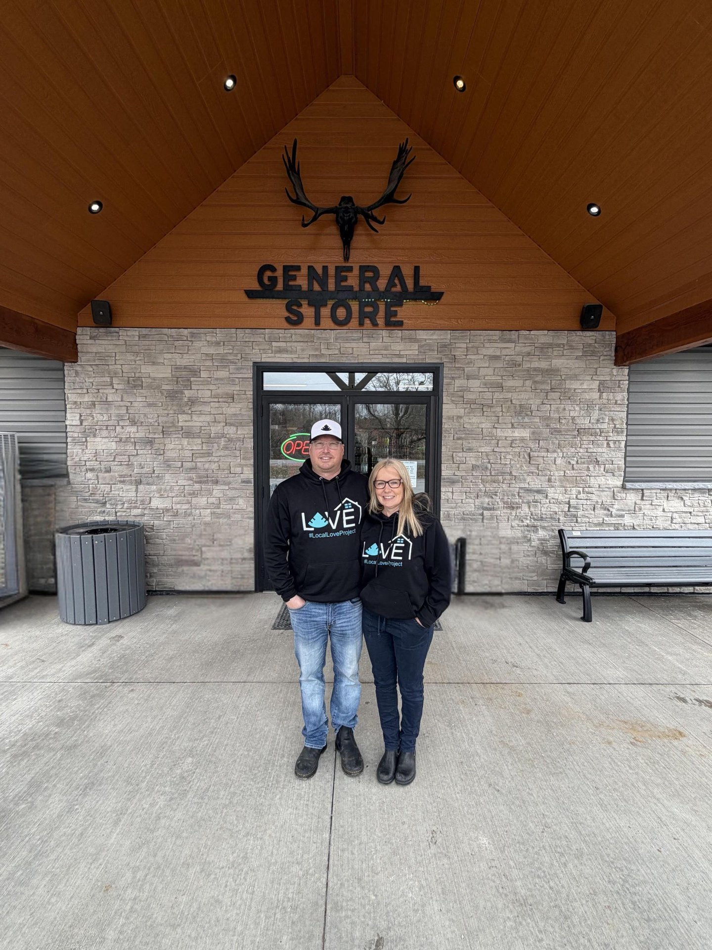 Owners of Sweetleaf standing outside, in front of their store.