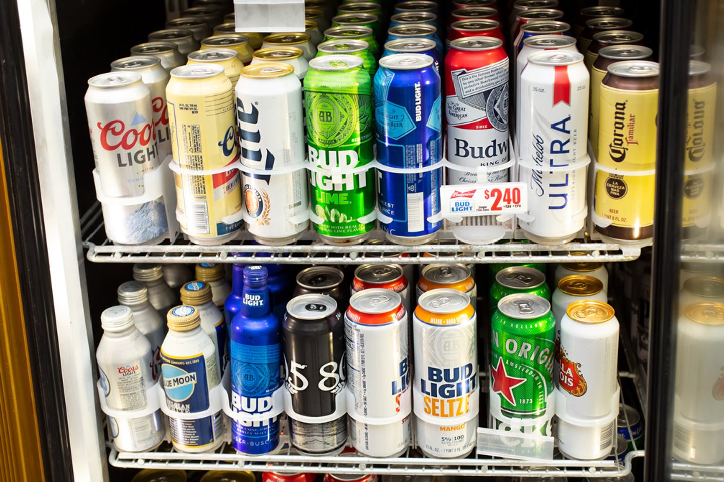 American beers seen behind glass in a convenience store fridge