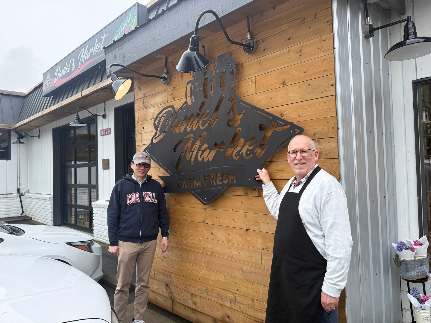 Daniel Tsai and Evan Milner in front of the store