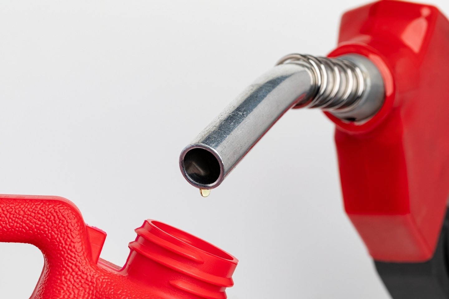 fuel pump dripping a single drop of oil into a jerry can