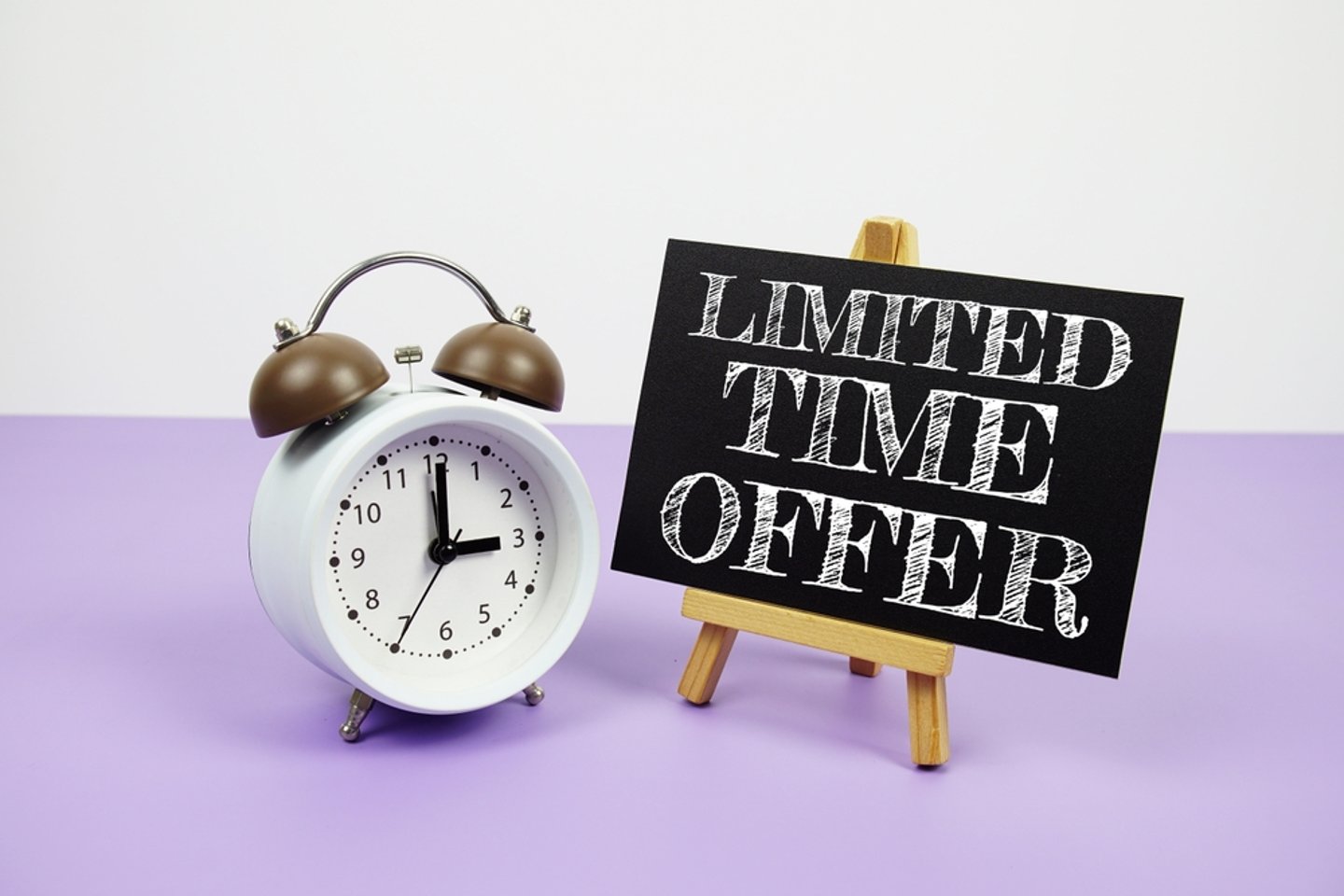 alarm clock next to a chalkboard sign that reads, "limited time offer"