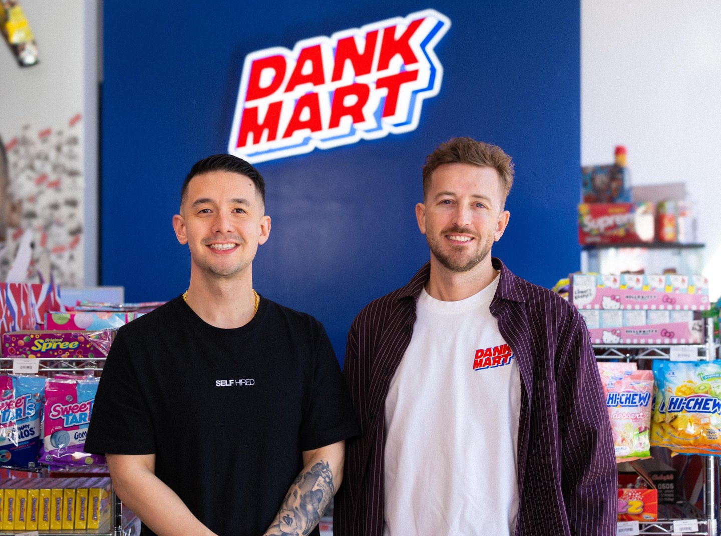 Kevin Wong (left) and Mike Smaill (right) in front of their counter with Dank Mart sign behind them.