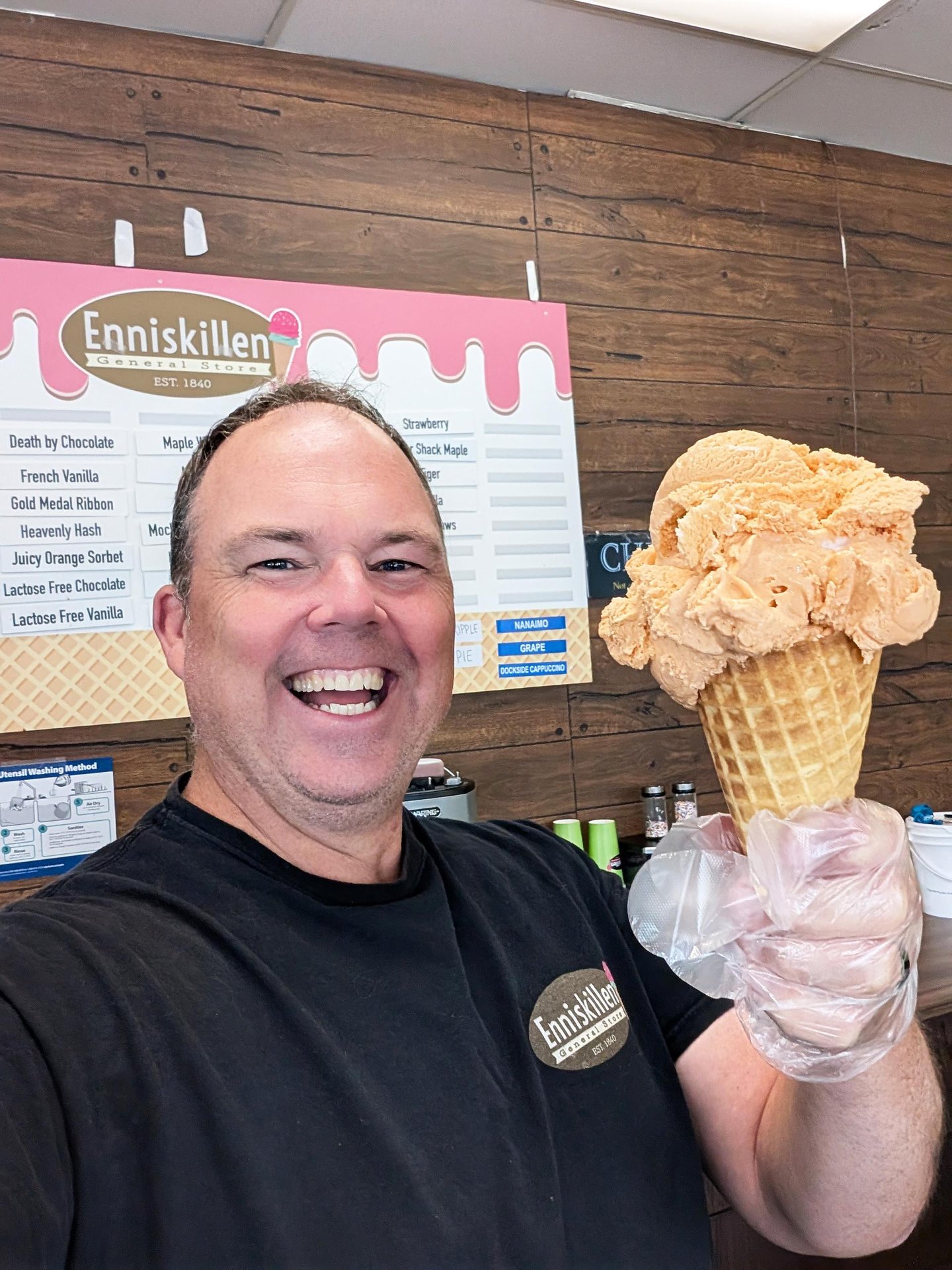 Enniskillen General Stores owner, Thomas Sheehan holding an ice cream cone.