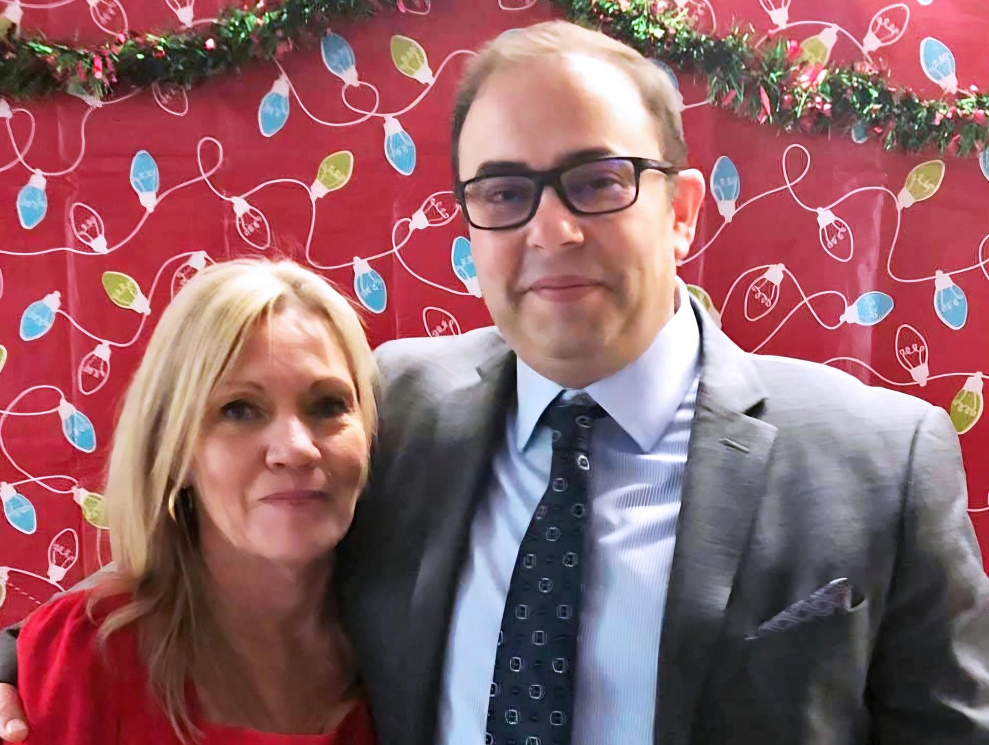 Red Pine and Golden Eagle owners,  Tracey Bullock and Todd Nadon in front of a festive background.