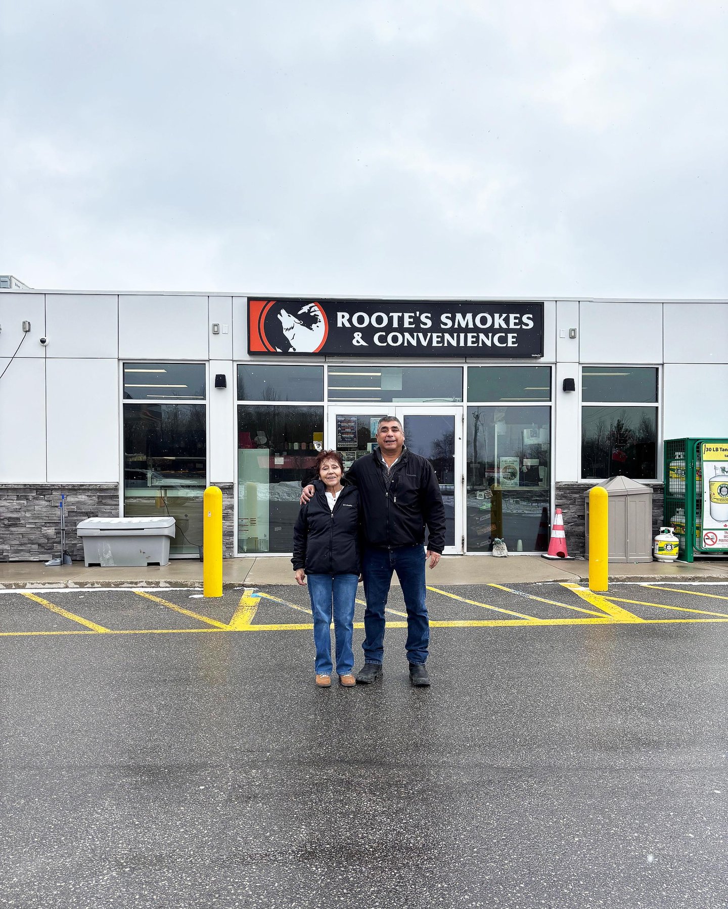 Owners: Brenda and Randy Roote in front of their gas pumps at Roote's Gas Barote"s