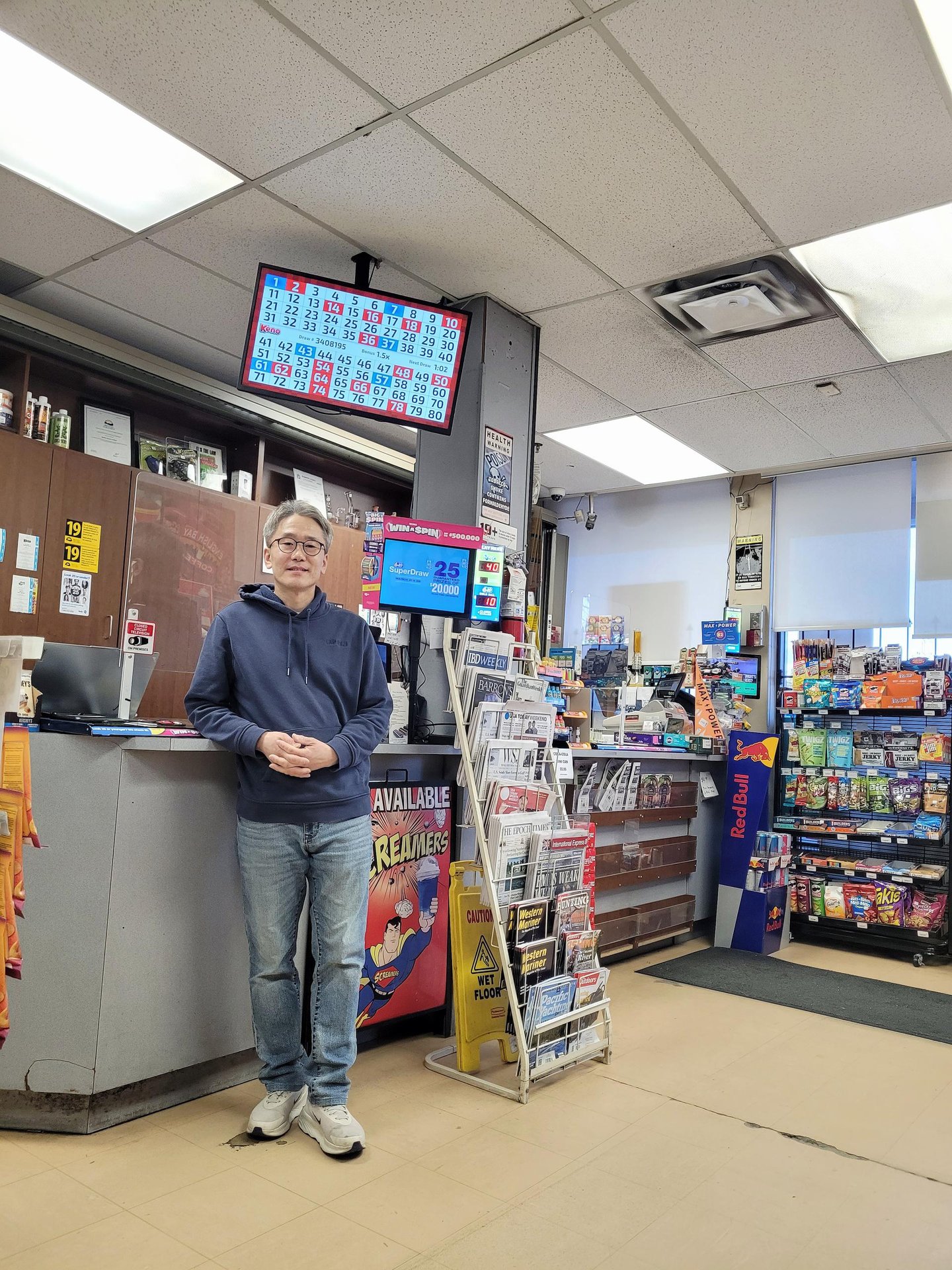 Sean Lee stands in front of the counter in his store, Seafair Smoke & Mixers