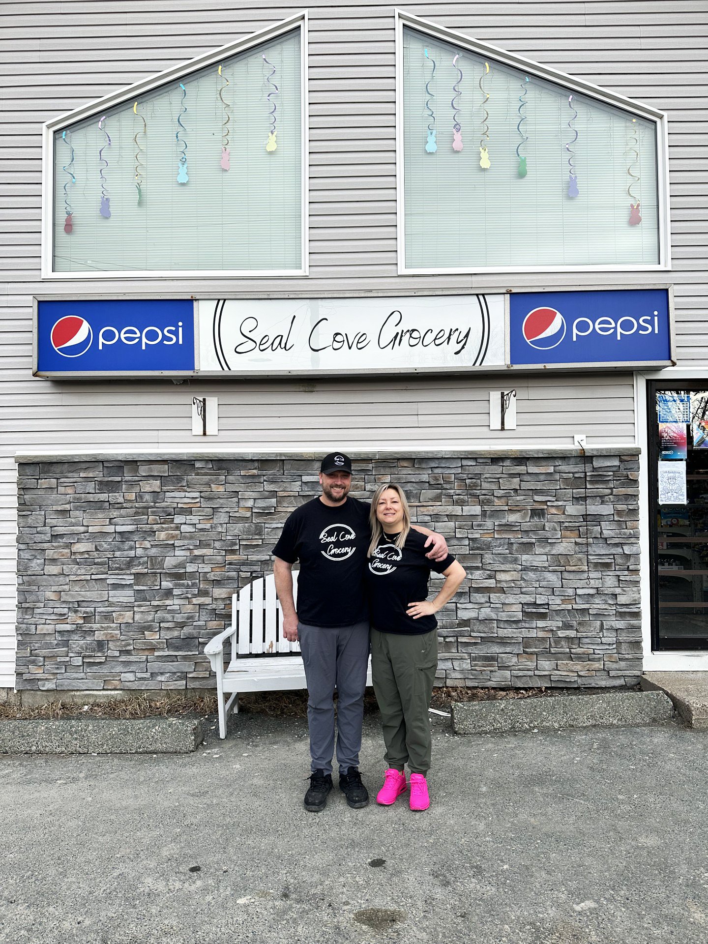 Owners of Seal Cove Grocery & Liquor Express, Kristen and Thomas Dwyer stand in front of their store
